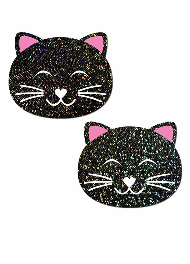 A pair of nipple pasties of a black cat with glitter and pink ears showcased on a white background.