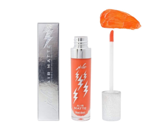 A close up of air matte liquid lipstick in Confidence standing next to a box with a lightning bolt on it.