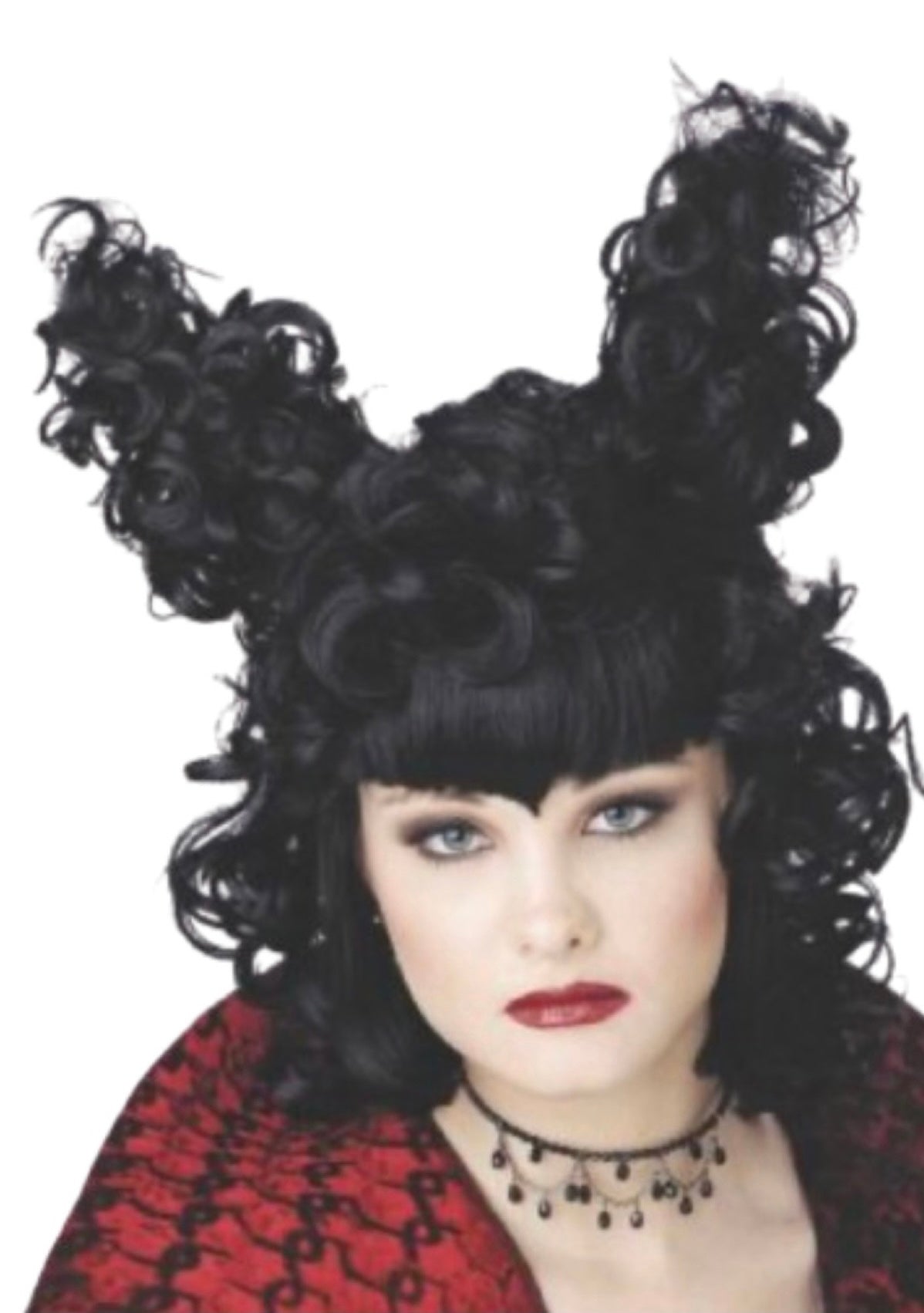 A woman posing wearing a black curly wig with two projections on top.