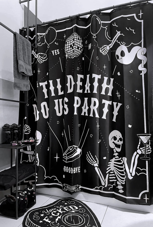 A black shower curtain with white text and skeletons.
