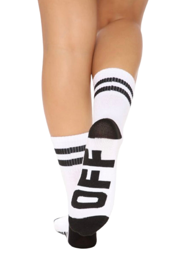A woman wearing white striped crew socks with the verbiage “ Off “ written in black on the bottom.
