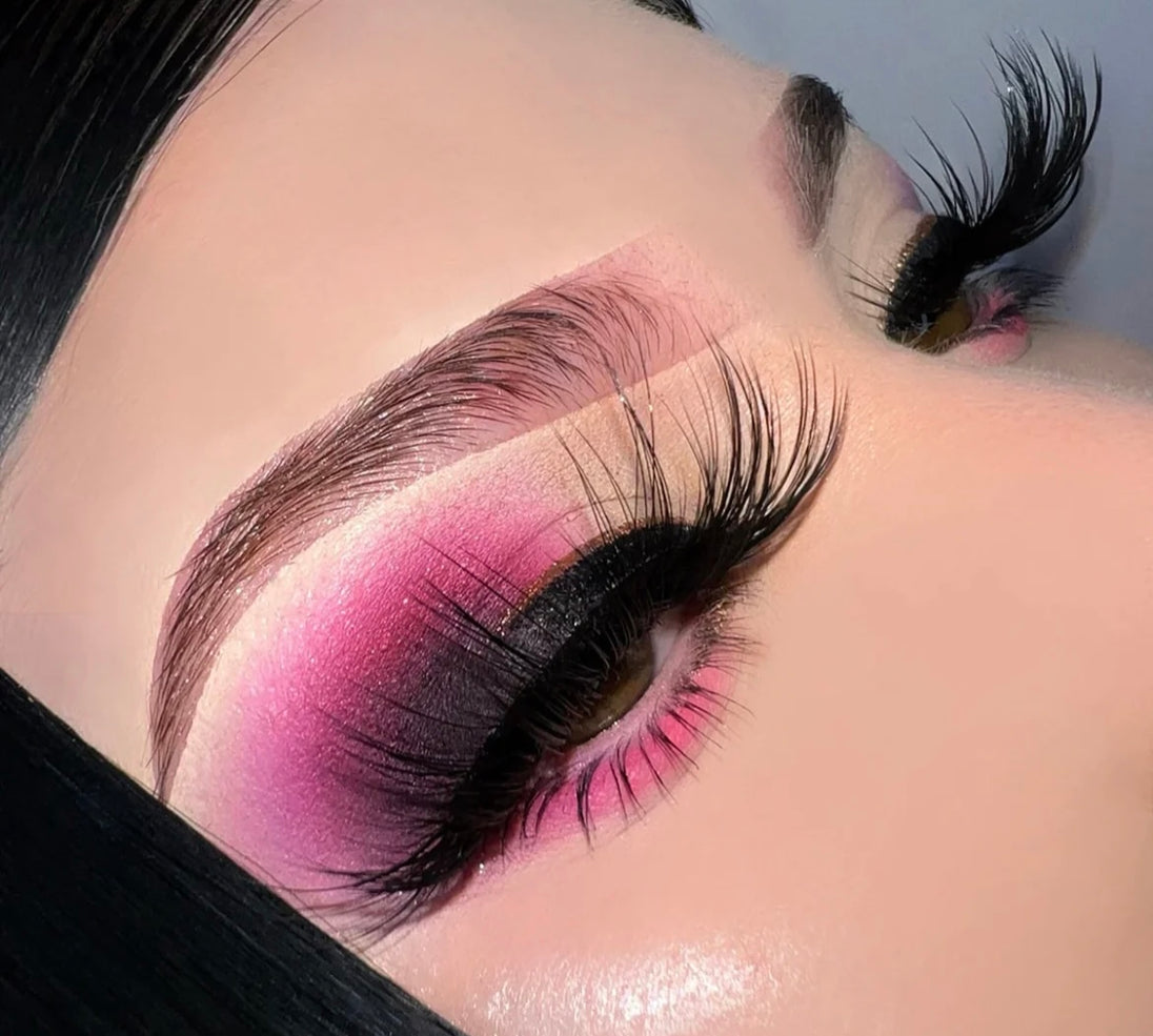 A close up of a woman’s face and eyes wearing bold color eyeshadow and a pair of It Was All A Dream Premium 3d Mink - 25mm False Eyelashes.