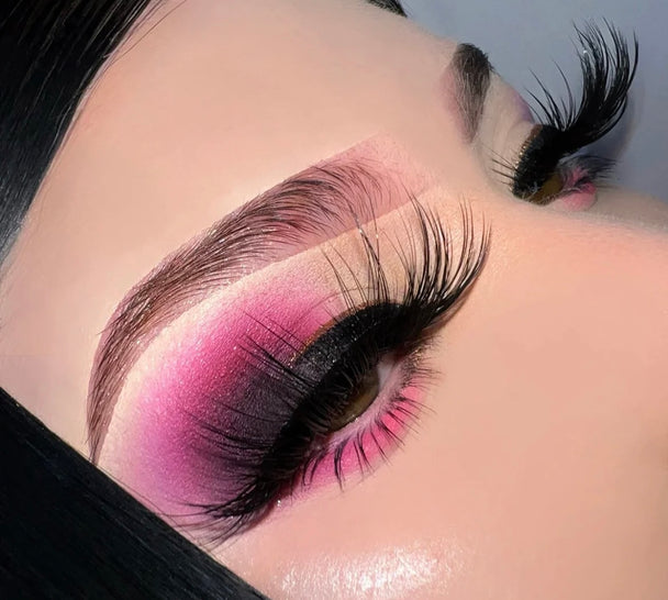 A close up of a woman’s face and eyes wearing bold color eyeshadow and a pair of It Was All A Dream Premium 3d Mink - 25mm False Eyelashes.
