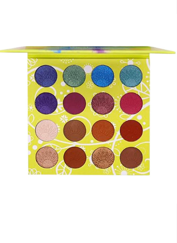 A close-up of the Revelry Eyeshadow Palette which includes sixteen mattes and glam shimmer shades. Colors included in palette are royal blue shimmer, dark brown in shimmer and matte and many others.