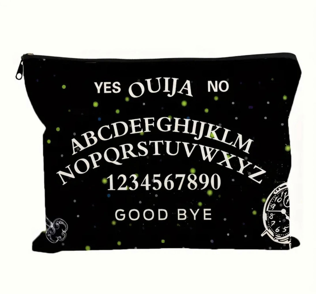 A gothic print makeup bag in black with “ ouija yes no goodbye “ written on it showcased on a white background.