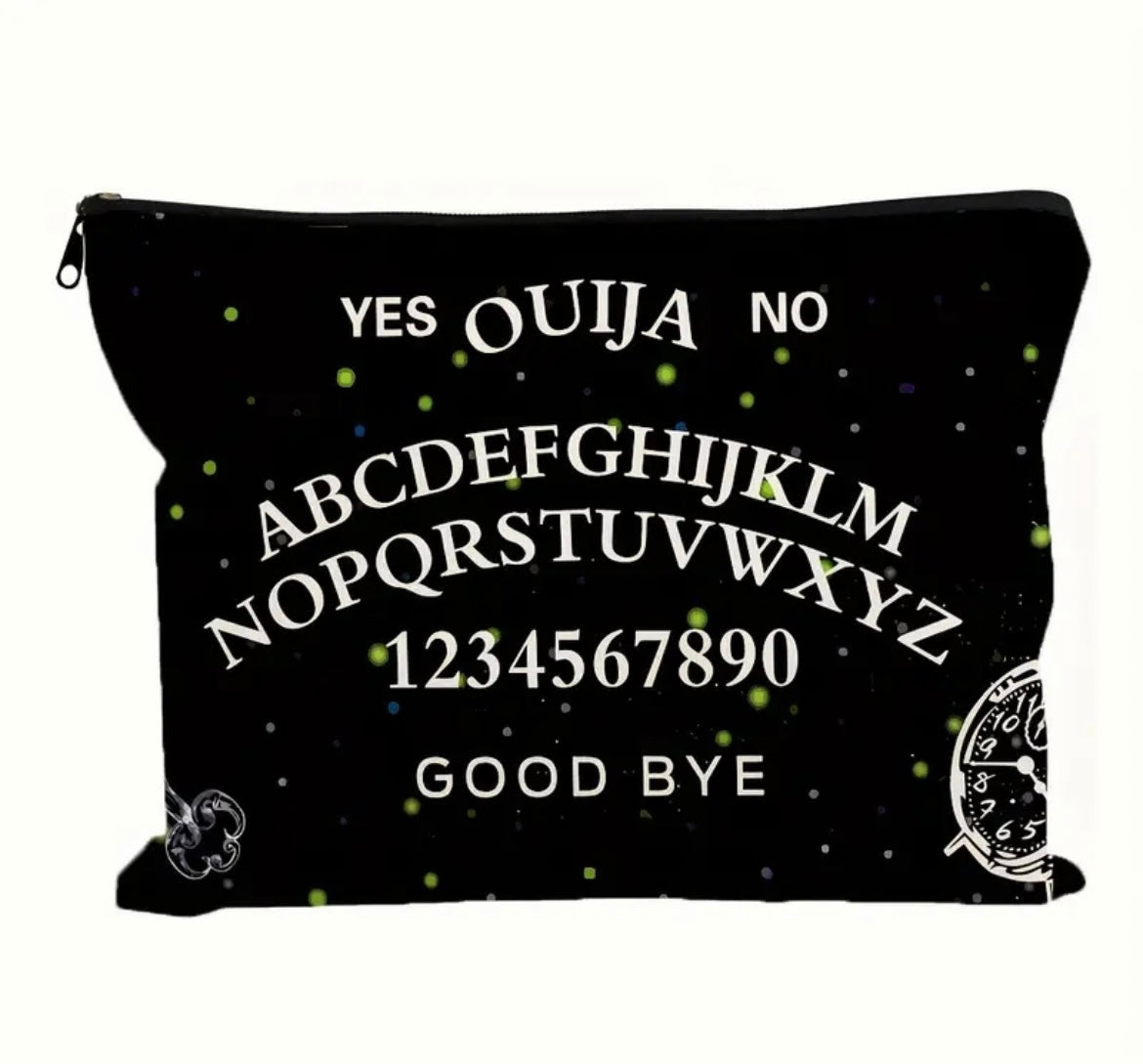 A gothic print makeup bag in black with “ ouija yes no goodbye “ written on it showcased on a white background.