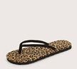 A close up of one leopard patterned flip-flop showcased on a tan background.