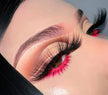 A close up of a woman’s face and eyes wearing Girl Fight Premium 3d Mink - 25mm false eyelashes with vibrant color eyeshadow.