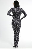A female posing from the back wearing a bats full body bodysuit in black without the full head mask.