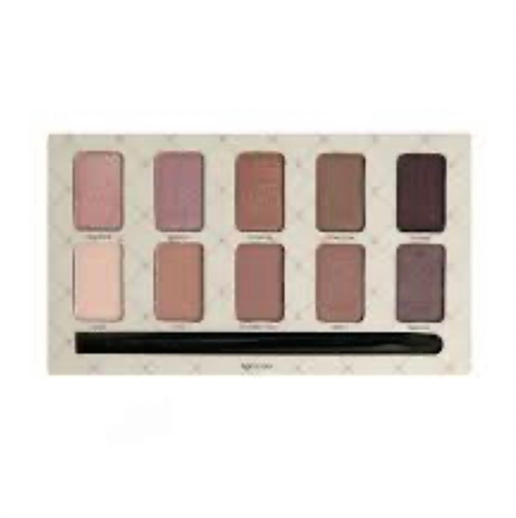 A close-up of a makeup palette with ten nude shades.
