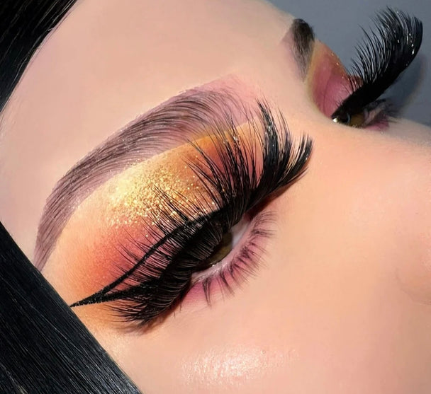 A close up of a beautiful woman’s face wearing bold color eyeshadow with a pair of Glamour Premium 3d Mink - 25mm false eyelashes.