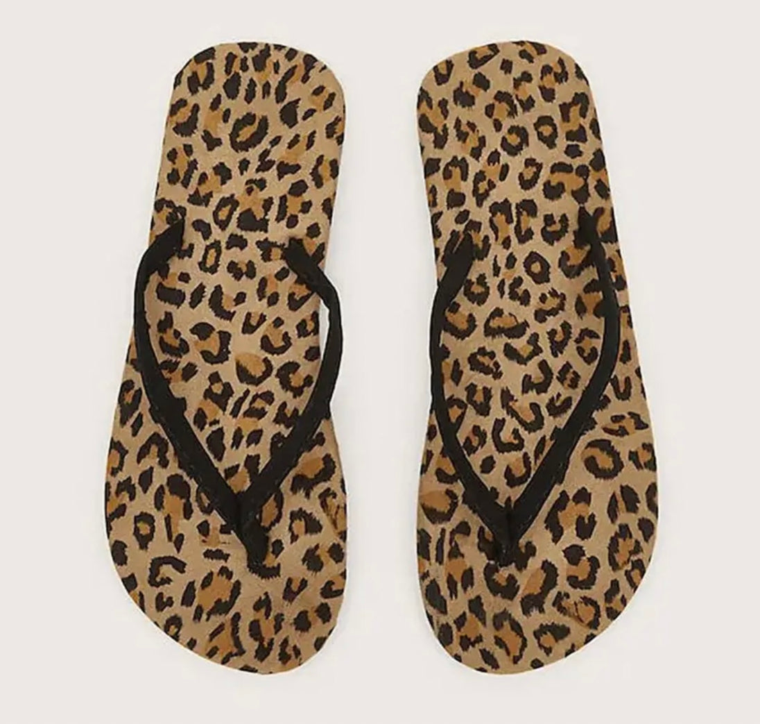 A pair of leopard patterned flip-flops. Perfect for casual summer wear and walks on the beach.
