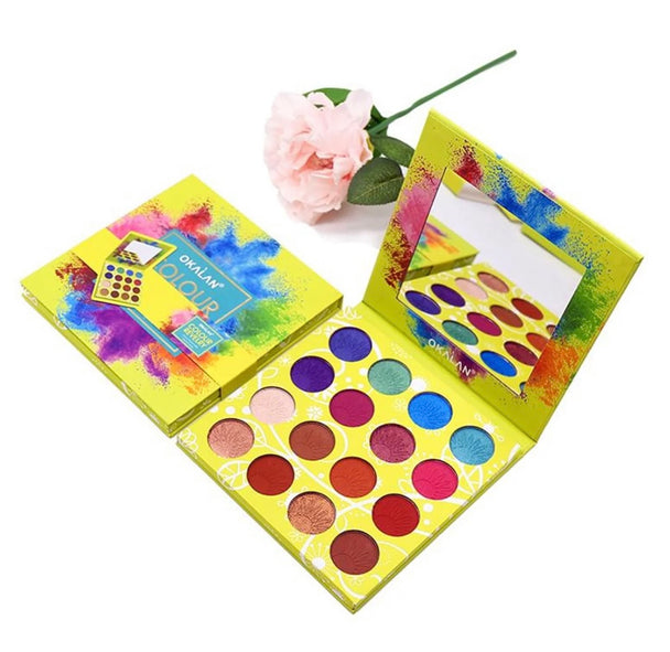 A close-up of two revelry eyeshadow palettes. One palette shows the sixteen matte and glam shimmer shades while the other palette is closed displayed on a white background with a rose.