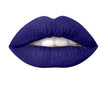 A close up of lips wearing dark blue lipstick.