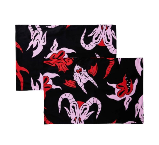 A pair of black pillowcases with pink and red characters.