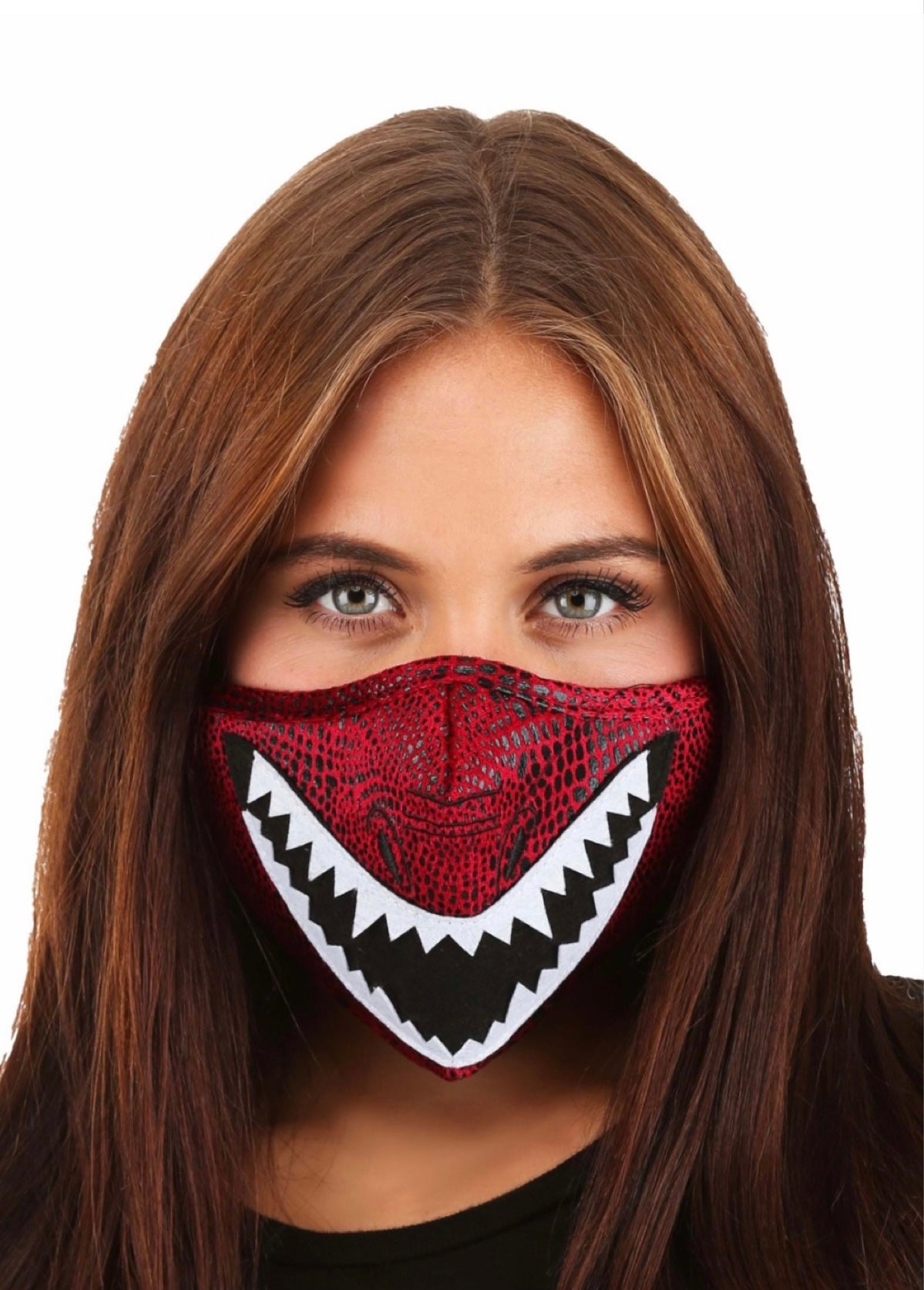A female wearing a red face mask with white dragon teeth on it.